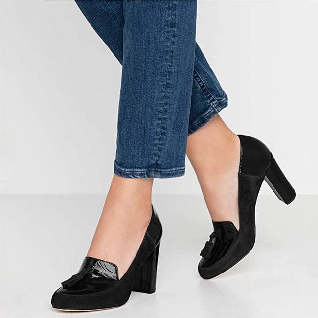 model wearing chunky black heels with fringe