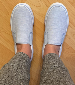 reviewer wearing the gray slip ons
