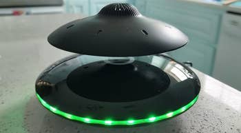 reviewer's levitating UFO speaker with green glowing base