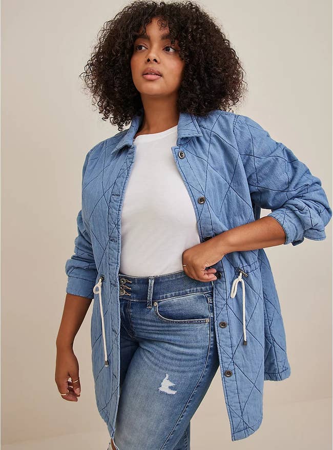 a model wearing the denim quilted jacket