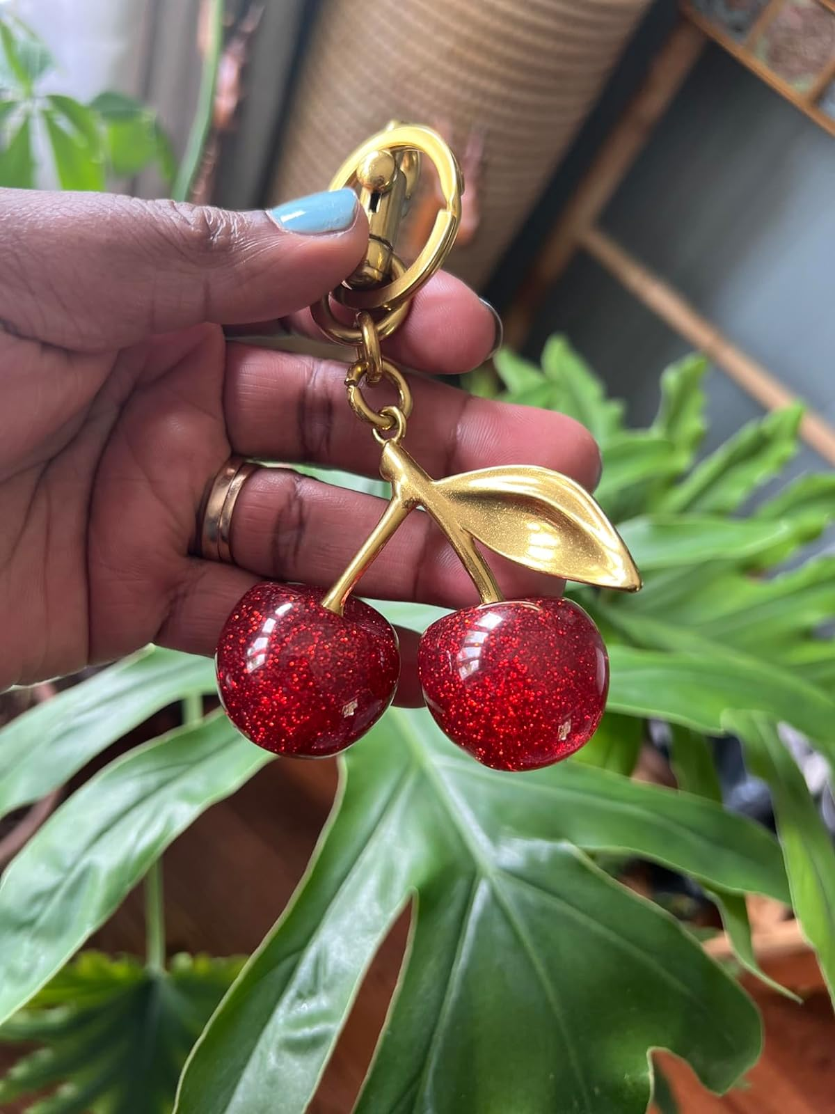 hand holding the red cherry keychain