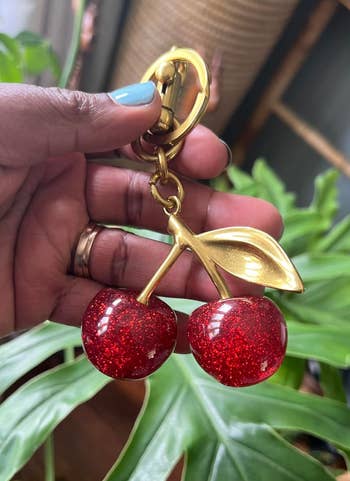hand holding the red cherry keychain