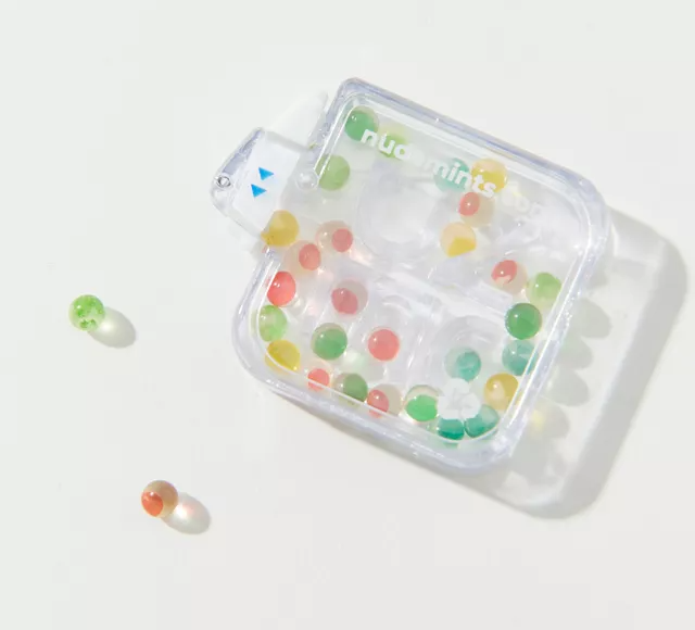 tiny rainbow balls in plastic maze container