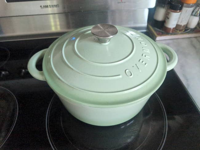 A formed  robust  Dutch oven with a lid sits connected  a stovetop, suitable for dilatory  cooking oregon  baking recipes