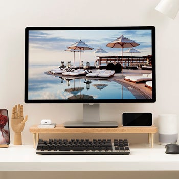 a monitor on the light wood riser