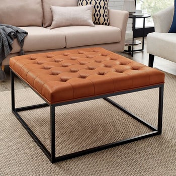 lifestyle photo of brown leather square ottoman
