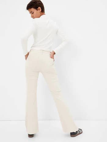back of model wearing the beige pants with a white top
