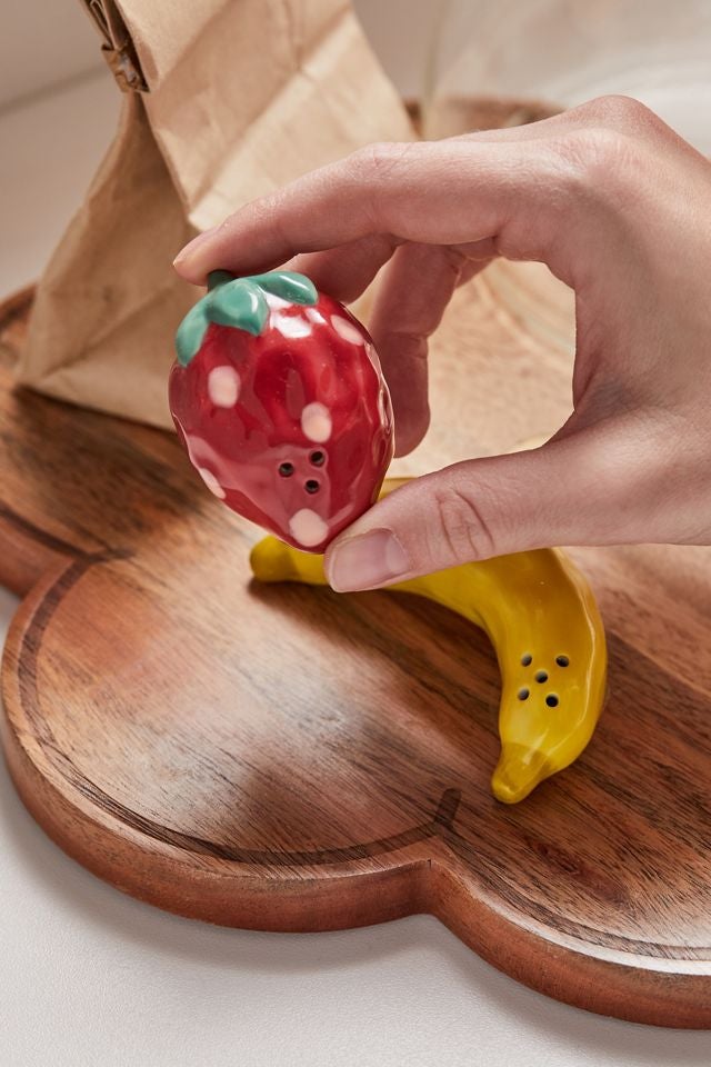 a hand holding the strawberry shaker