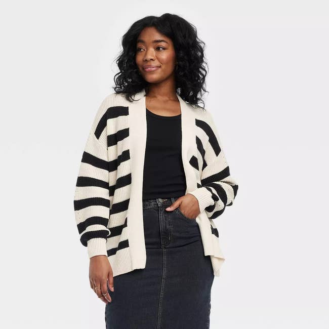 model in cream sweater with black stripes
