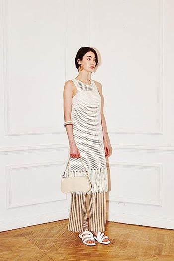 model holding a tan croc-embossed vegan leather purse