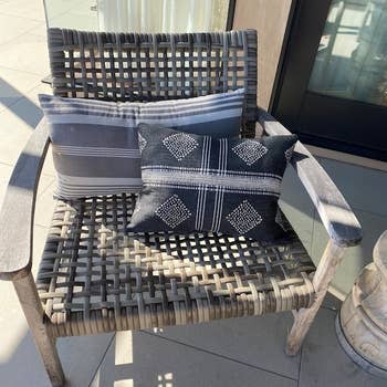 the same gray pillow in a different shape, sitting on an outdoor chair