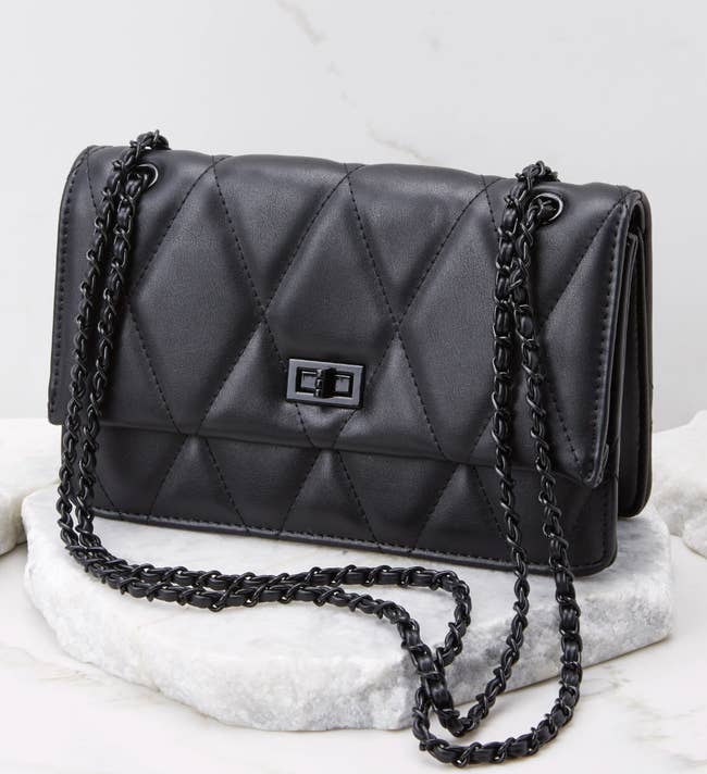 the quilted bag in black with a black chain strap
