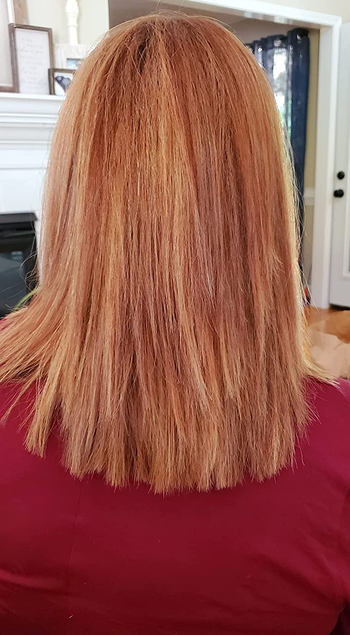 Back view of reviewer's red straight dyed hair with red shirt on 