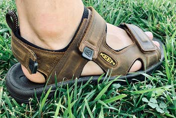 reviewer photo wearing the sandal in the grass