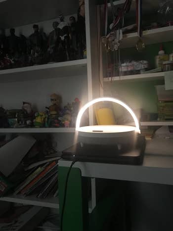 The lamp lit on a reviewer's side table