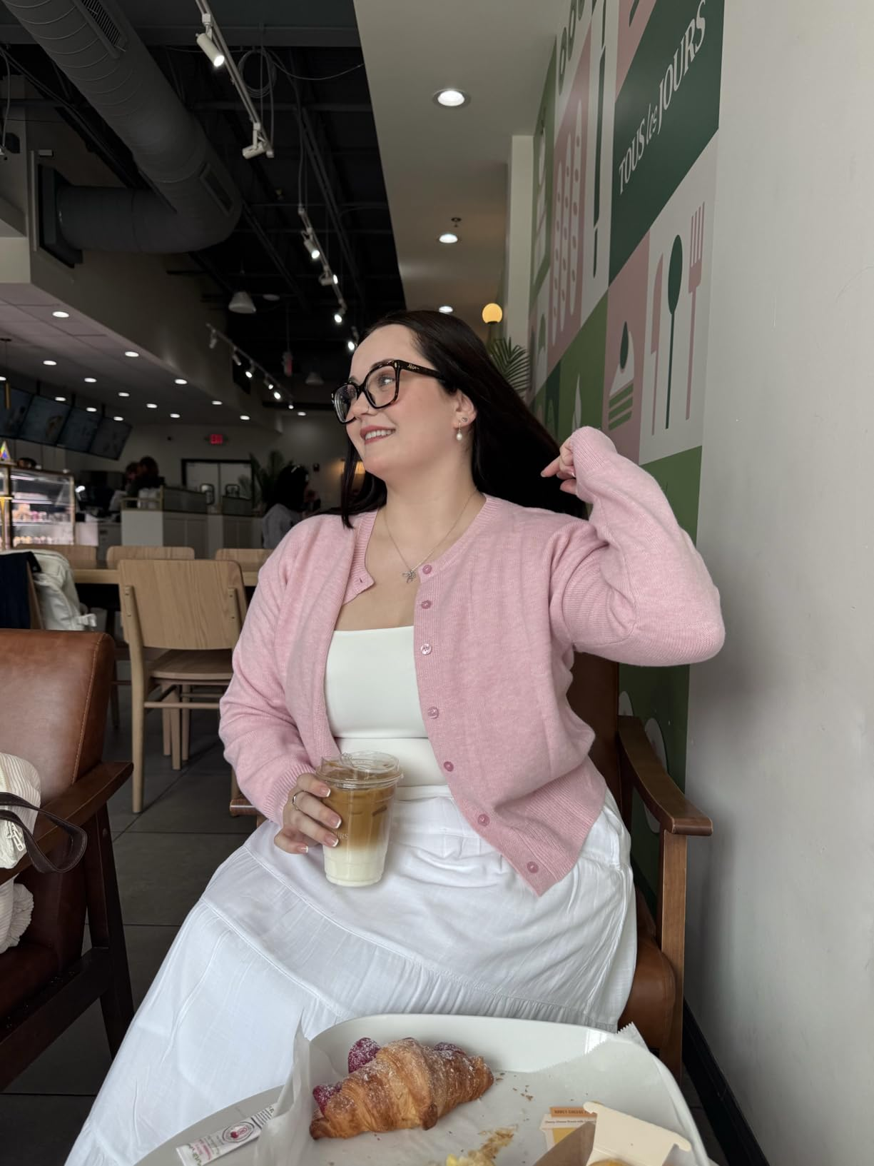 different reviewer sitting successful  a cafe wearing the cardigan successful  pink