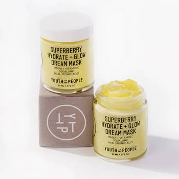 two tubs of the yellow face mask, one open and the other closed