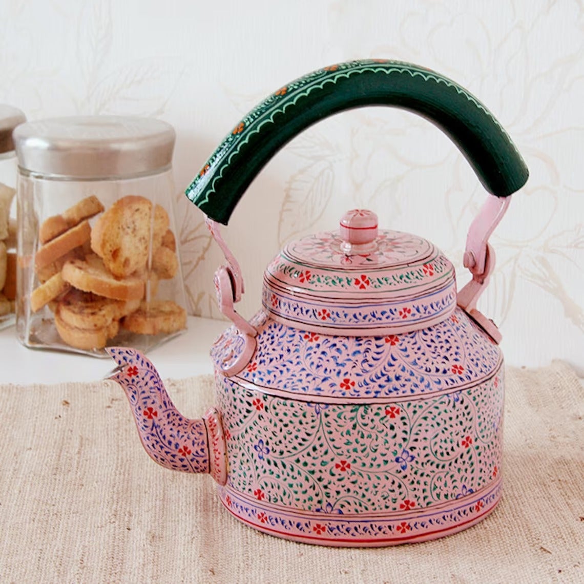 The pink kettle with a green floral handle