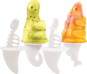 four molds for different types of dinos with skeleton shaped sticks and tail shaped handles