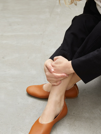 another model wearing the toasted almond flats
