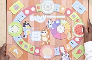 Person holding a Bluey-themed board game titled