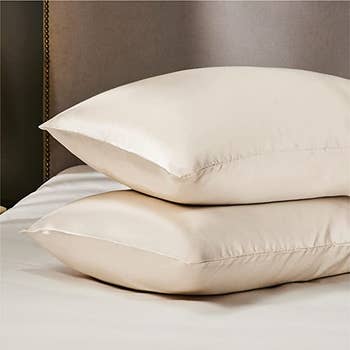 two stacked pillows encased in a cream pillow case