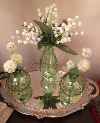 a reviewer' metallic  reflector  tray with flowers connected  it