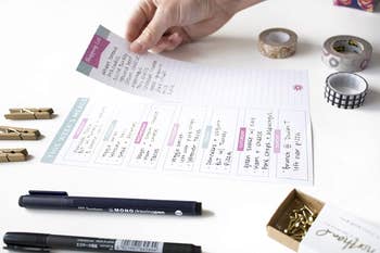 the perforated side of the planner with the ingredients list for shopping being torn off to take on the go