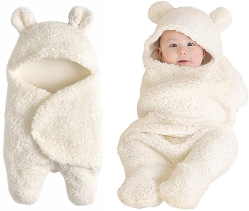 Model wrapped in cream sherpa baby blanket with teddy bear hood with ears