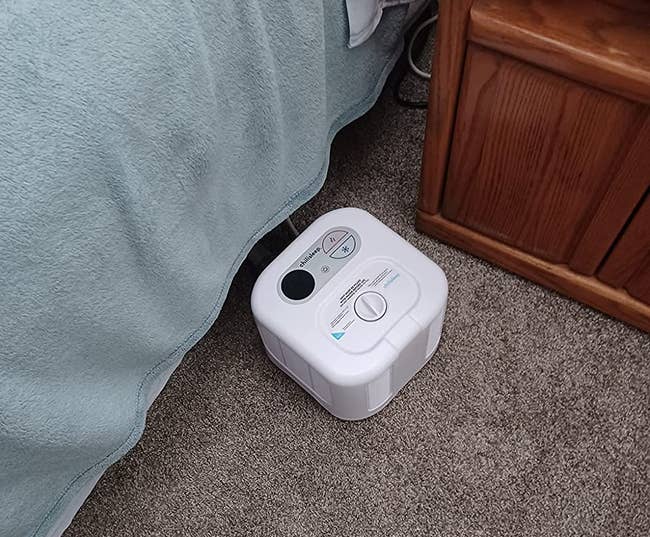 a reviewer's ChiliSleep cube next to a bed 