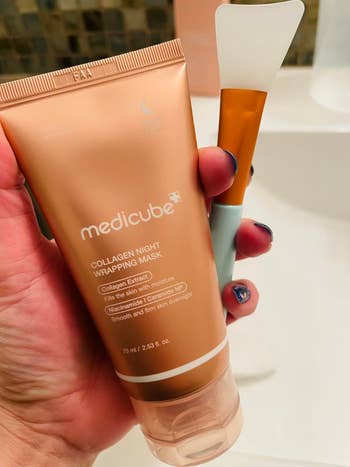 Hand holds Medicube Collagen Night Wrapping Mask tube and applicator