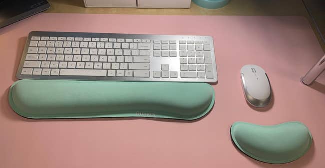 reviewer's mint green wrist and mouse pad by a keyboard and mouse