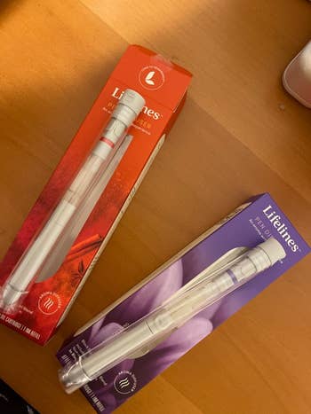 Two Lifelines aromatherapy pens successful  reddish  and purple