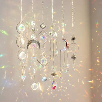Hanging crystal suncatchers make  dazzling airy  patterns with geometric and satellite  shapes, perfect  for location  decor