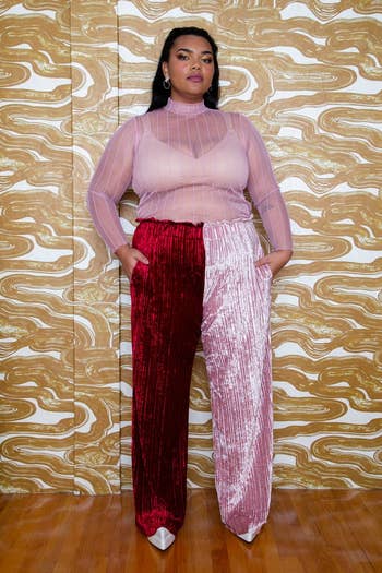 model in a sheer top and color-blocked velvet pants