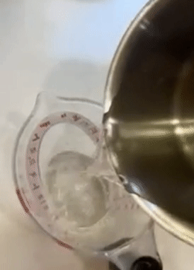 gif of reviewer pouring liquid into the measuring cup from overhead, since the measurements can be seen from above