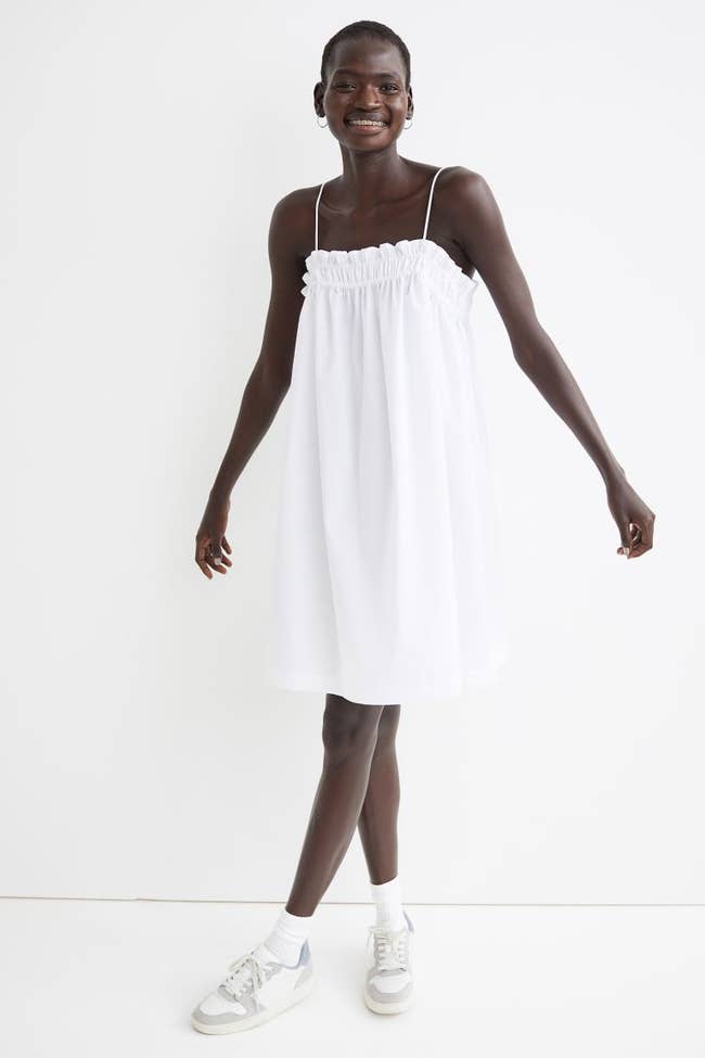 model wearing white spaghetti strap dress
