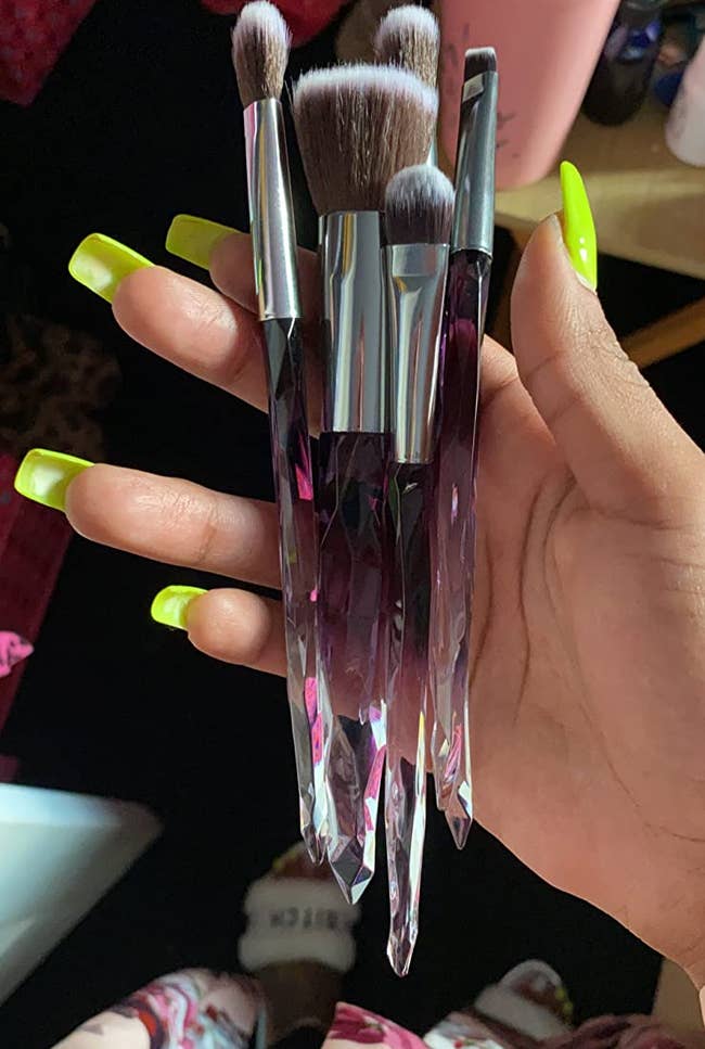 a reviewer shows a closeup of the purple and clear brushes