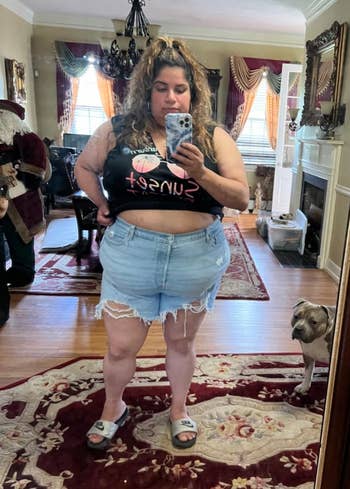 Woman taking a reflector selfie, wearing a