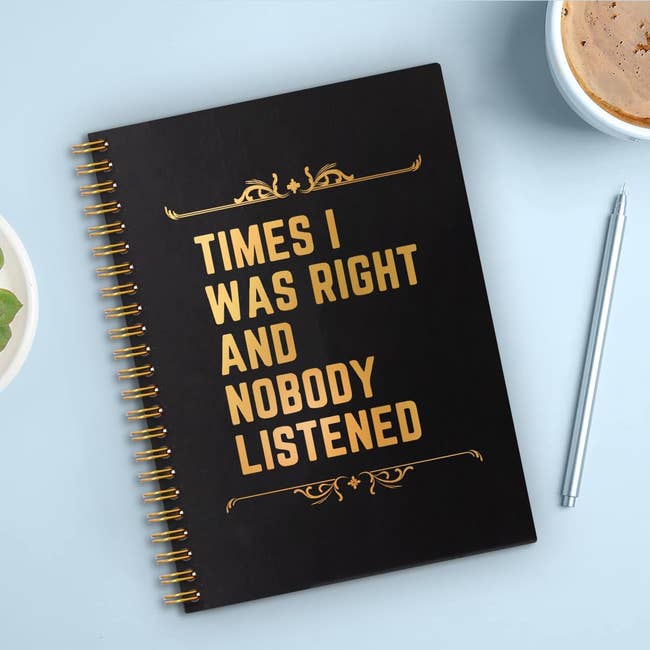 Black spiral notebook with gold text: 