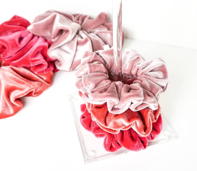 pink scrunchies on an acrylic scrunchie stand
