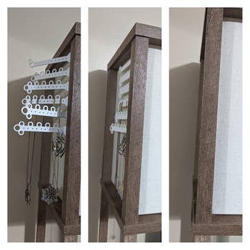 Close-up of a woody jewelry furniture with hanging hooks and necklaces