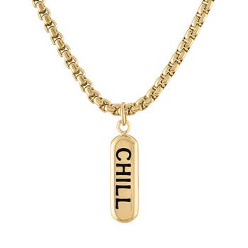 Gold necklace with a pendant spelling 'CHILL' for article on trendy jewelry