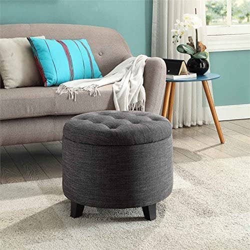 round storage ottoman with legs in a living room