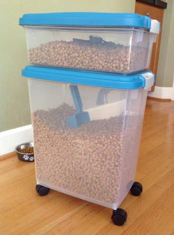 the stacked blue storage containers with pet food inside