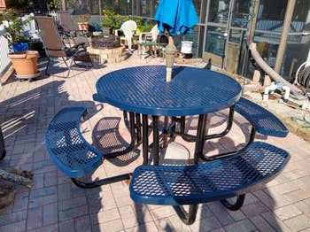 reviewer photo of round picnic table with attached benches by the pool