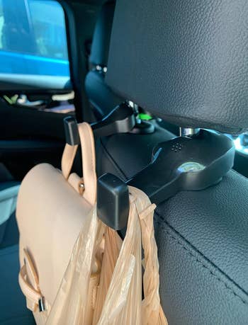 reviewers hook connected to seat holding bags