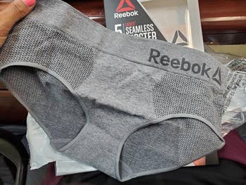 reviewer holding a brace of grey Reebok underwear