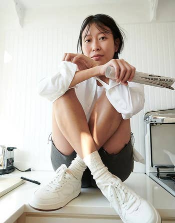 model wearing the achromatic  sneakers