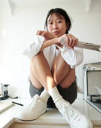 model wearing the white sneakers